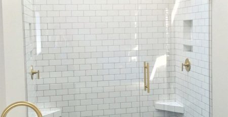 Auckland bathroom tiling project by Top End Tiling: Stylish bathroom with subway wall and herringbone shower floor tiles.