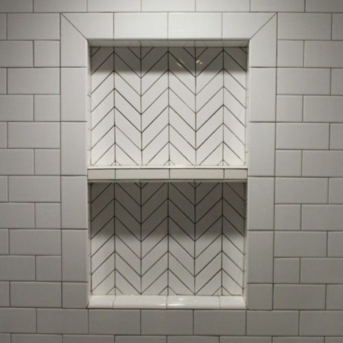 Top End Tiling Auckland project: Expertly tiled shower with custom shower niche design. NZ tiling solutions.