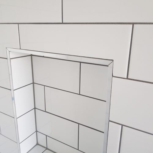 Auckland shower renovation by Top End Tiling, featuring a stylish tiled shower niche for organised storage. NZ design.