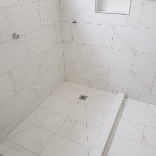 Top End Tiling, tiler Auckland: Showcase of a stylish bathroom renovation with unique tile work.