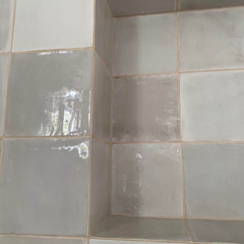 Top End Tiling Auckland project: Expertly tiled shower with custom shower niche design.