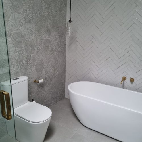 Auckland tiler: Top End Tiling project featuring a modern bathroom with patterned and herringbone tiles.