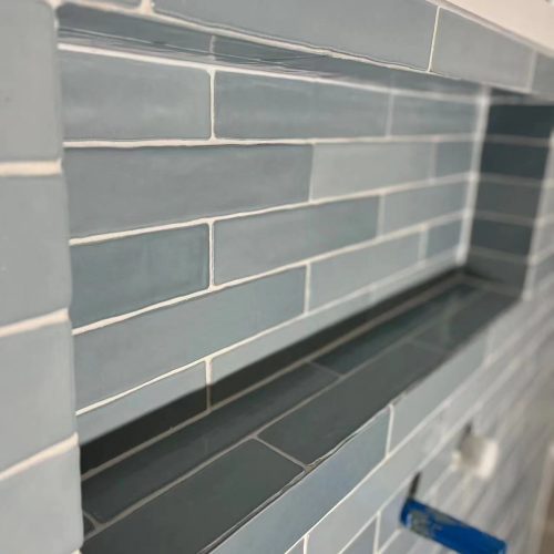 Top End Tiling Auckland project: Expertly tiled shower with custom shower niche design. NZ tiling solutions.