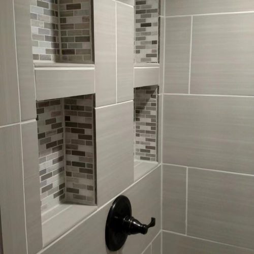 Top End Tiling Auckland project: Expertly tiled shower with custom shower niche design. NZ tiling solutions.