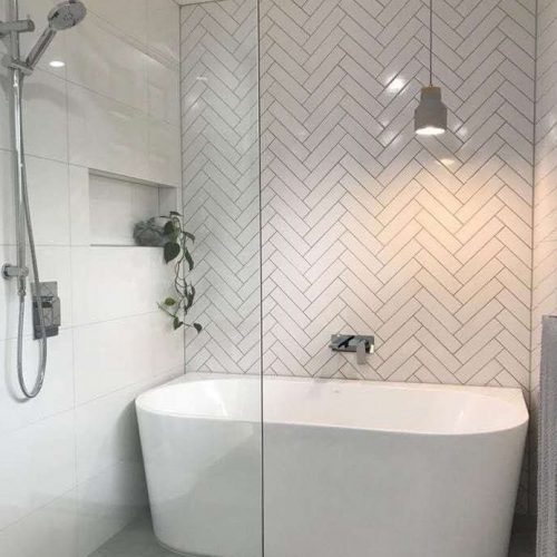 Auckland tiling project by Top End Tiling: Stylish bathroom with herringbone shower tiles.